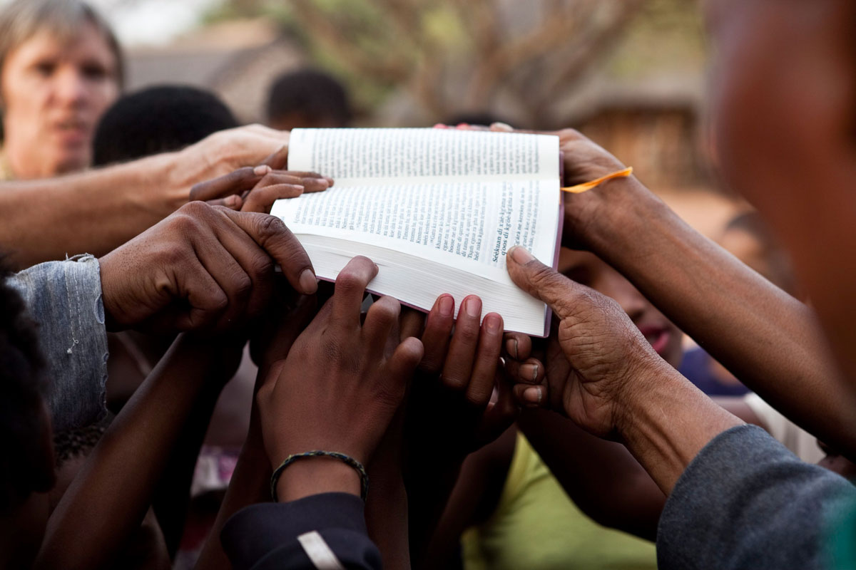 People holding up God’s Word.